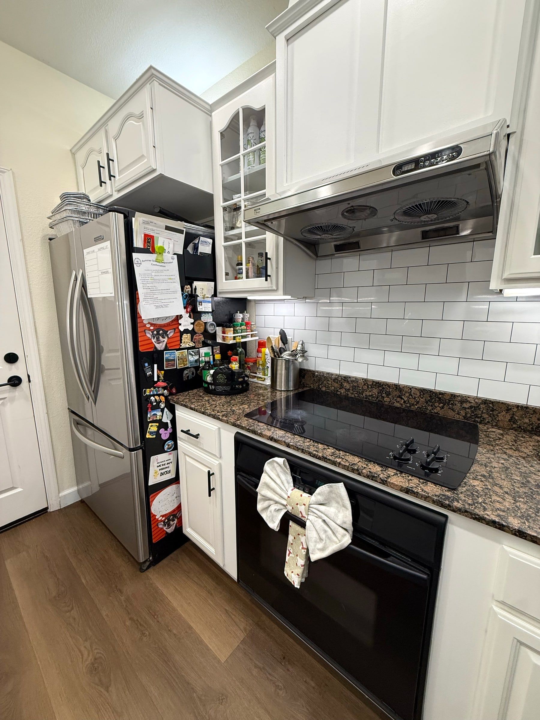 White kitchen with clean counters, stovetop and floors after a regular cleaning